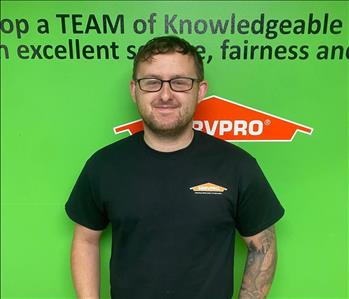 Male employee in front of SERVPRO signage