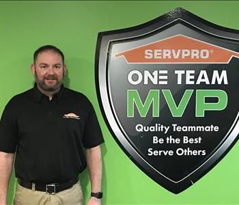 Owner standing next to SERVPRO MVP One Team Signage
