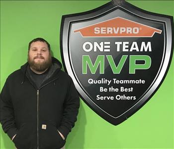 Male employee in front of SERVPRO One Team signage